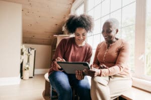 Mother and Daughter looking at options on a tablet