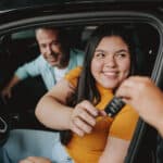 Customer receiving car keys at Dick Says Yes after auto financing approval.